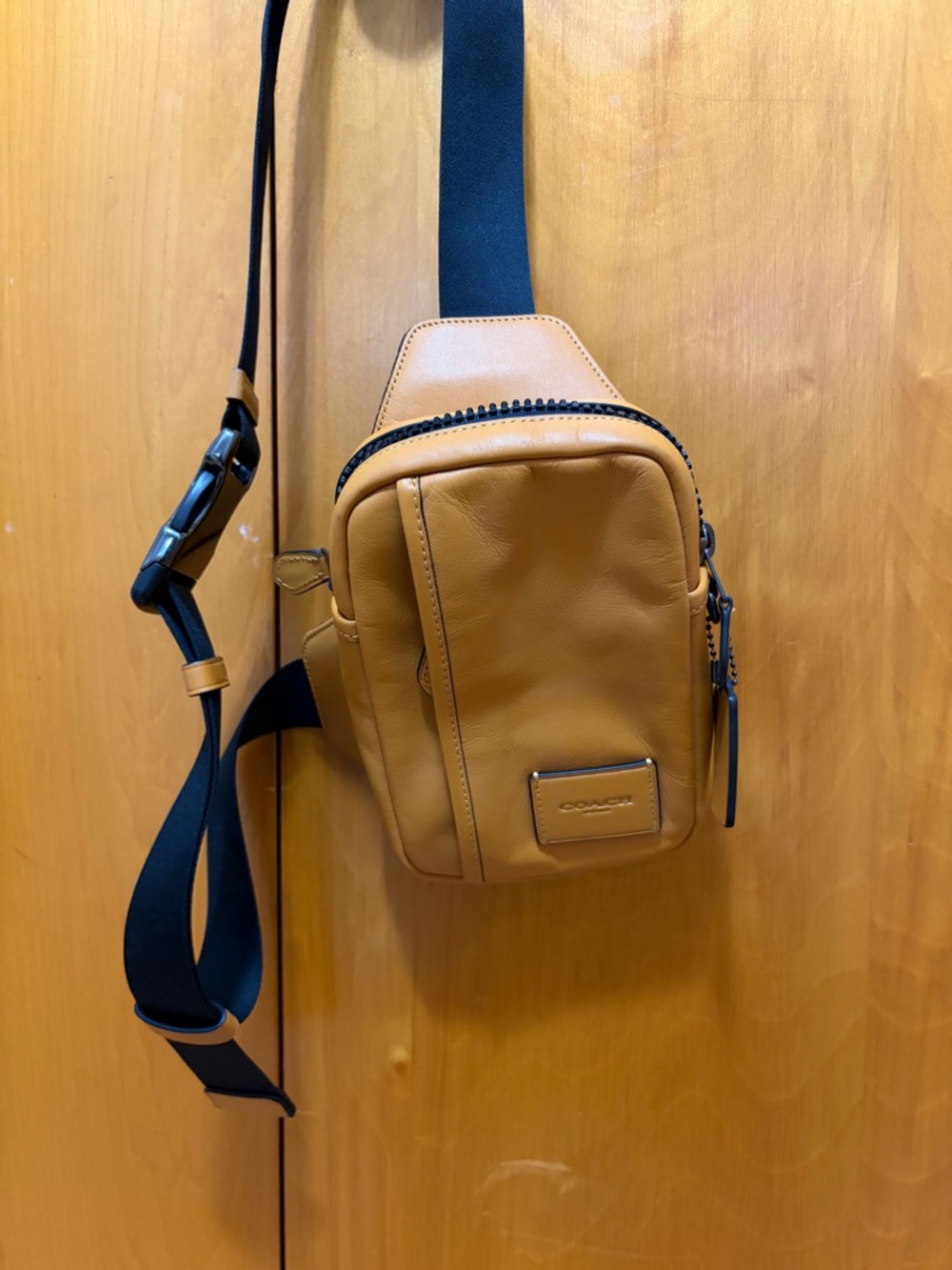 Coach Men’s Tan Leather Sling Bag with Black Strap